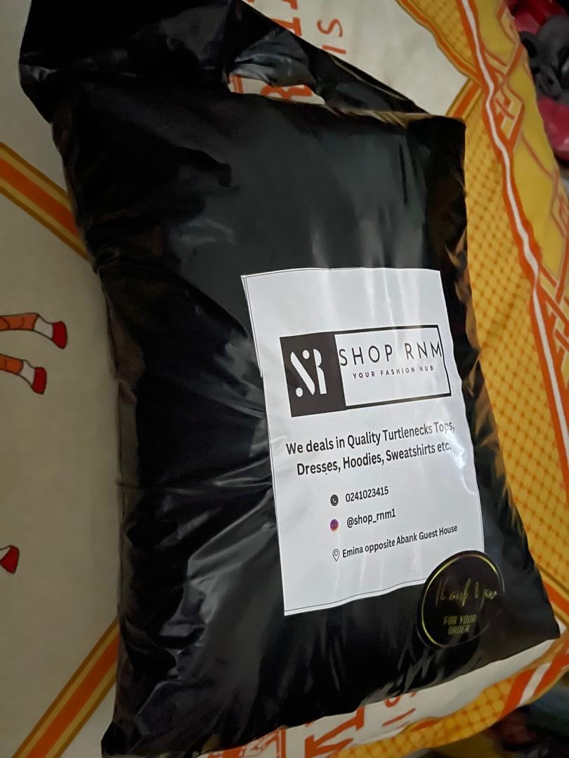 A black parcel packaged and branded by SHOP RNM